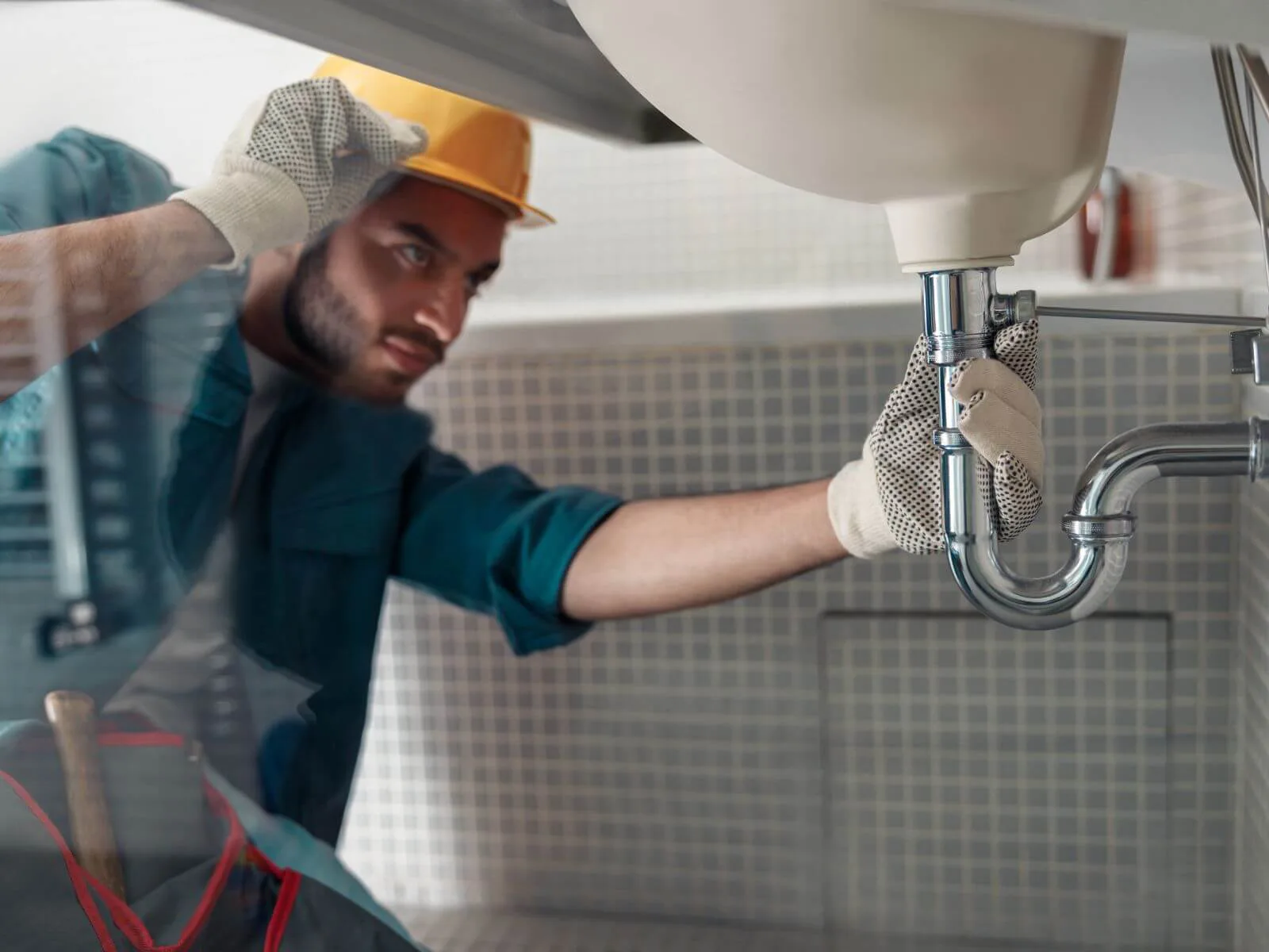 Plumber working on residential plumbing emergency